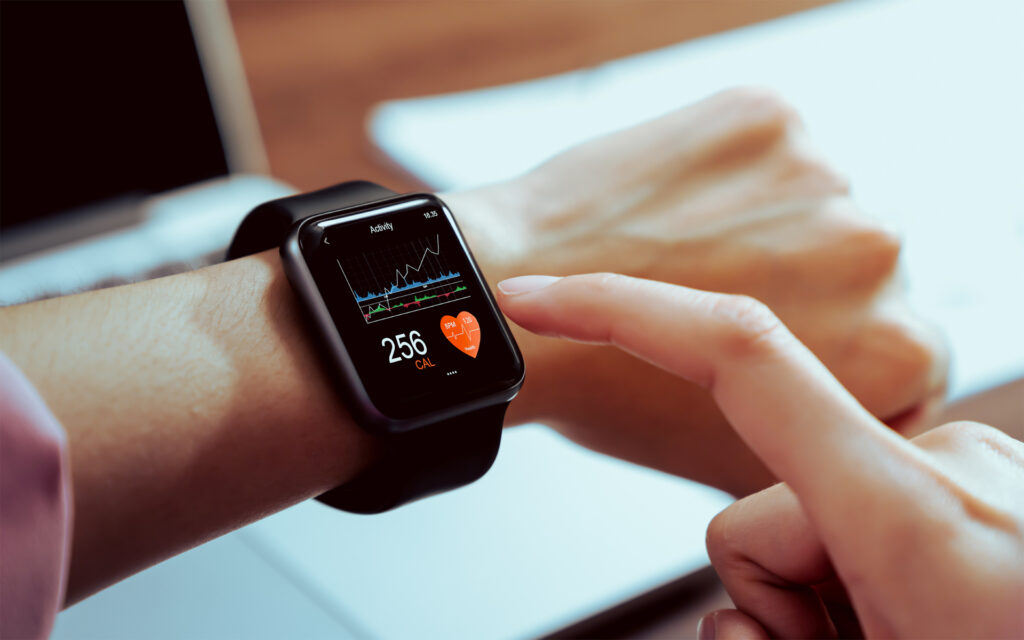 Close up of hand touching smartwatch with health app on the screen, gadget for fitness active lifestyle.